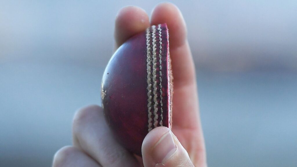 Ollie Robinson holds up his half of the match ball after taking five wickets for England against Pakistan at Headingley
