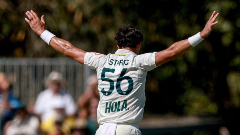 Mitchell Starc holds the ball aloft after reaching a 22-ball five-wicket haul against Bangladesh in the second Test at Mackay