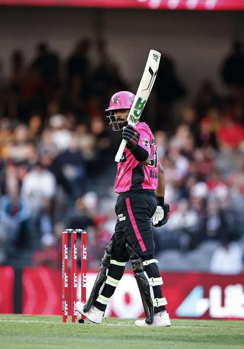 January 1, 2026, Melbourne, Victoria, Australia: BABAR AZAM of Sydney Sixers raises the bat after scoring a half century during match 18 of the KFC BBL|15 between Melbourne Renegades and Sydney Sixers at the Marvel Stadium on January 01, 2026 in Mel